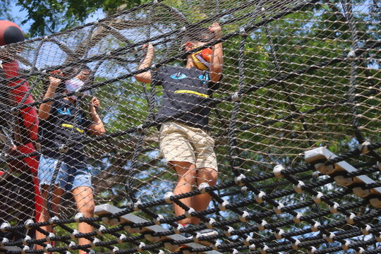 Asian Children With Masks At Outdoor Obstacle Course Playground