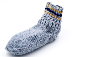 Hand-knitted sock in gray isolated on white