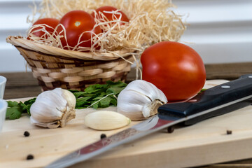 Tomatoes on the table and in the basket, olive oil and balsamic vinegar, garlic, vegetables, vegetarianism, healthy eating
