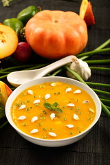 Bowl of delicious vegan diet meal- healthy organic pumpkin soup with fresh cream.