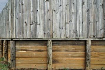wooden fence for home security with retainer wall