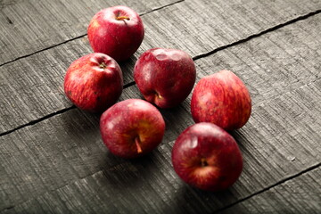 Delicious sweet ripe organic red apples on a rustic wooden background. 