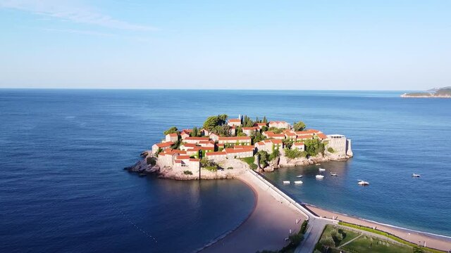 Aerial view of island with old history. Tourist attraction for many people. Drone shot of Sveti Stefan (Saint Stephen) island in Montenegro.