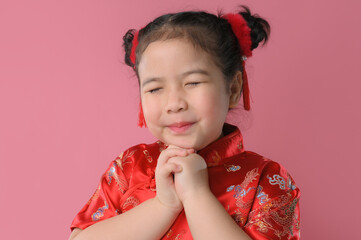 Smiling cute asian little girls in red chinese traditional dress.Happy Chinese new year concept.