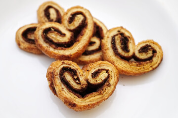selective focus, Cinnamon sugar palmiers on white plate.