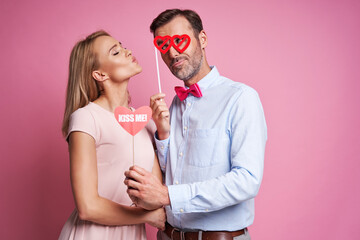 Caucasian mature couple in love posing  on pink background