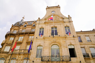 Fototapeta na wymiar city hall clock in france facade in town center french stone building in Beziers