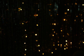 Fototapeta na wymiar Golden abstract bokeh background. sparkling lights . Abstract festive vintage lights and highlights are out of focus. The holiday of Christmas and New Year.