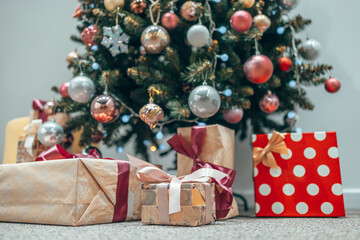Beautiful gifts under the Christmas tree. Christmas. Morning in the house. Holiday, Christmas tree toys, garland. New Year.