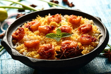 Indian street foods background- delicious seafood biryani cooked with prawns and shrimps.