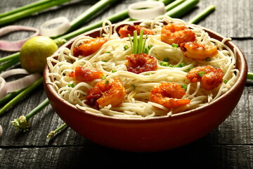 Bowl of tasty seafood noodles with fresh prawns . Asian recipes. 
