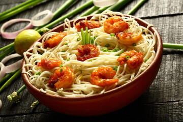 Asian street foods- delicious and spicy cooked seafood noodles with shrimps and prawns. traditional non vegetarian  recipes.