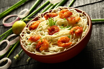 Homemade delicious seafood pasta with fresh shrimps, Asian cooking recipes backgrounds.