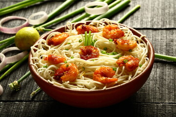 Asian street foods- delicious and spicy cooked seafood noodles with shrimps and prawns. traditional non vegetarian  recipes.