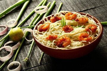 Asian street foods- delicious and spicy cooked seafood noodles with shrimps and prawns. traditional non vegetarian  recipes.