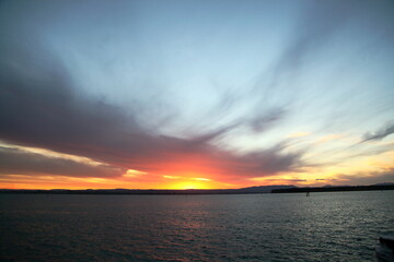 Fototapeta premium sunset, sunset with ship leaving harbour , Harbour sun set, 