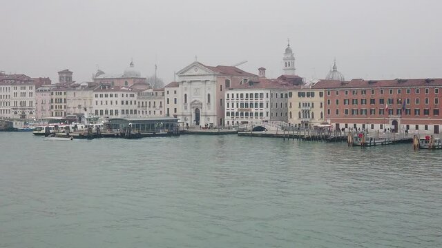 Venice, Italy - January 2022 - Traveling on the ferry that transports cars, along the Giudecca canal, among the splendid historic buildings of the lagoon city