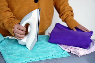 A housewife is going to iron her cloth. Concept : Daily household chore. Take care of clothes....