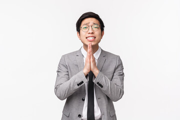 Waist-up portrait of hopeful desperate asian office worker, man begging for coworker cover him at...