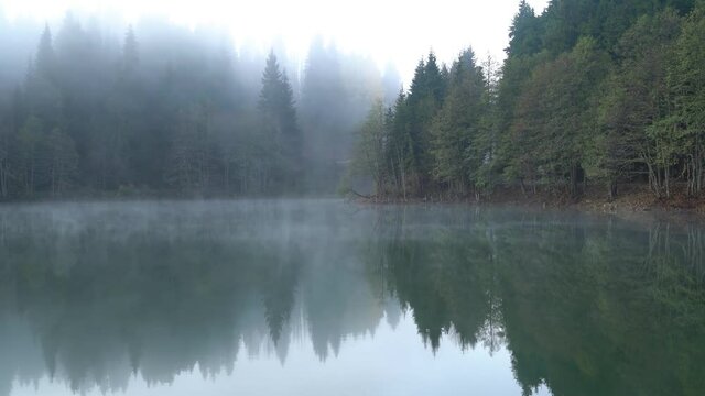 Savsat Karagol Black lake in Eastern Black Sea with morning evaporation. Savsat Karagol lake is a large trout lake in the forest in Savsat, Artvin, Turkey