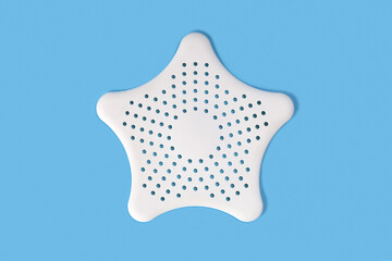 White clean silicone star for kitchen sink or bathroom filter, close-up on blue background