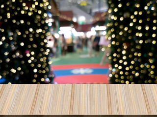 wooden table perspective, behind bokeh blur, are trees, lights and entrance-exit. Exhibitions in shopping malls.