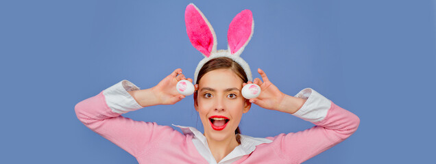 Easter banner with bunny woman. Lipstick kiss print on easter egg. Portrait of a happy woman in bunny ears.