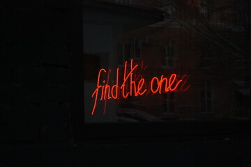 The sign says "Find the one", like "Find your dream, YOUR DREAM" - Powered by Adobe