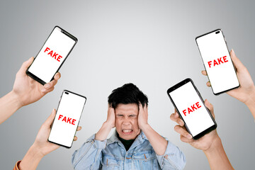 Stressful man getting fake news on the cellphone