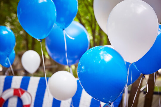 blue and white balloons with helium in close-up