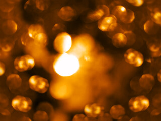 Golden warm colors festive sparkling defocused lights overlay. Orange and yellow bokeh abstract...