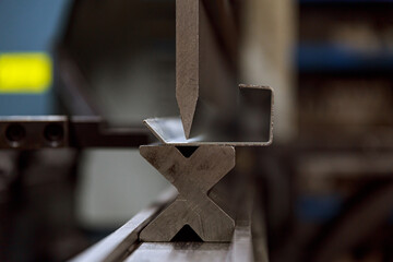 Modern hydraulic metal bending machine at a metallurgical plant. Bending of sheet metal.