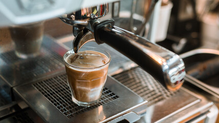 black coffee with milk on a coffee maker