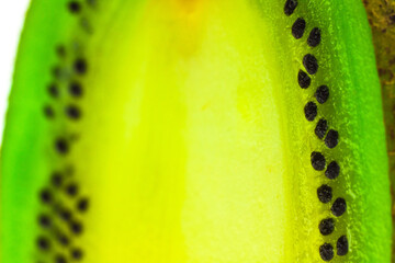 Fresh, ripe kiwi fruit macro shot. Kiwi pulp and seeds. Slice of kiwi close up. Tropical fruit