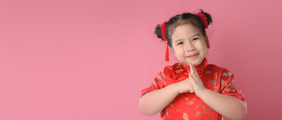 Smiling cute asian little girls in red chinese traditional dress.Happy Chinese new year concept.