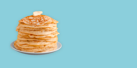Staple of yeast pancakes with butter. Spring Shrovetide Maslenitsa holiday, Russian pancake day or week. american crepes isolated on blue background banner, place for text
