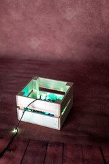 wooden box with garland on bold background