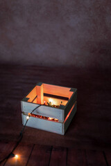 Fototapeta premium wooden box with garland on bold background