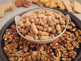 Groundnuts or peanuts filled bowl with walnuts. Super winter foods, these punjabi folk foods are full of protein which will keep you warm in winter along with marunda, gachak and jaggery for sweet. 