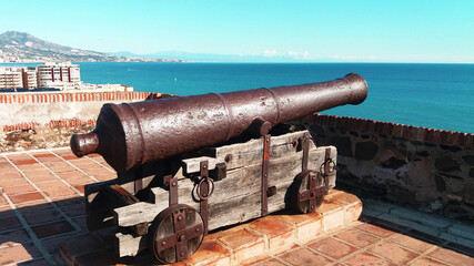 Fototapeta na wymiar cast iron cannon aimed at the sea. country defense concept. illustration of medieval travel