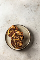 Three slices of zebra cake on a plate, top view, copy space, isolated