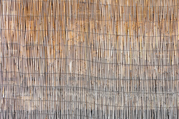 Organic bamboo mat garden fence background, arranged in a row pattern, stock photo image