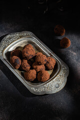 Dark chocolate truffle on dark background