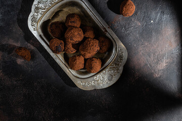 Dark chocolate truffle on dark background
