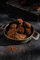 Dark chocolate truffle on dark background