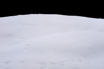 Fototapeta na wymiar a pile of snow isolated against a black background