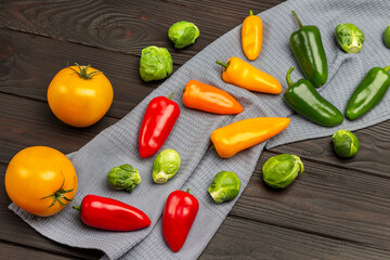 Multicolored vegetables on gray napkin.