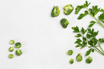 Cabbage and sprigs of parsley on white.