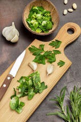 Chopped cabbage and parsley leaves on board and in coconut shell.