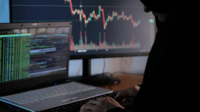 male hacker steals cryptocurrency at night, hacks into exchange and security system, steals token and blockchain data from users. Writes computer code